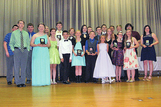 Winners of Take-A-Bow Awards gather on stage at the Riverdale auditorium.